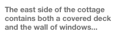 The east side of the cottage contains both a covered deck and the wall of windows...